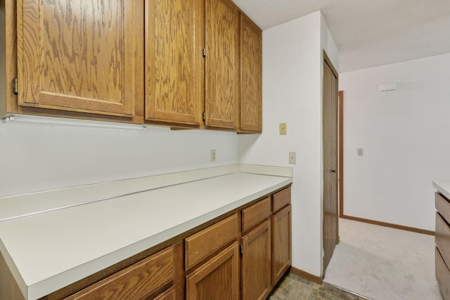 3635 Saint Francis Way Unit B, Eagan, MN 55123 - kitchen with brown cabinetry, light countertops, and carpet