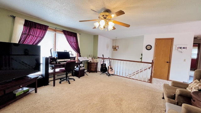 carpeted office space featuring a textured ceiling and a ceiling fan