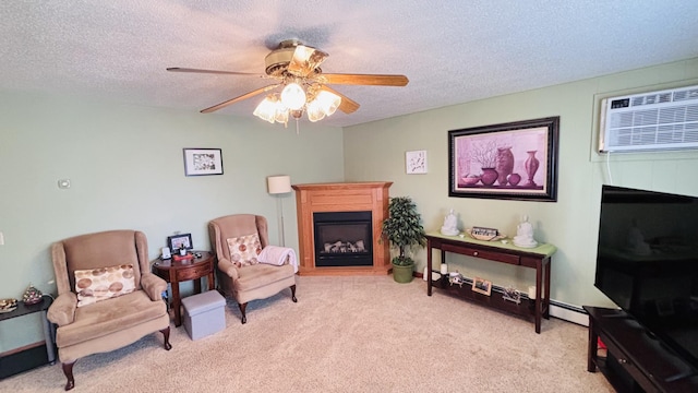 sitting room featuring ceiling fan, carpet, a textured ceiling, a glass covered fireplace, and a wall mounted AC