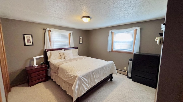 bedroom with light carpet, a baseboard heating unit, and a textured ceiling