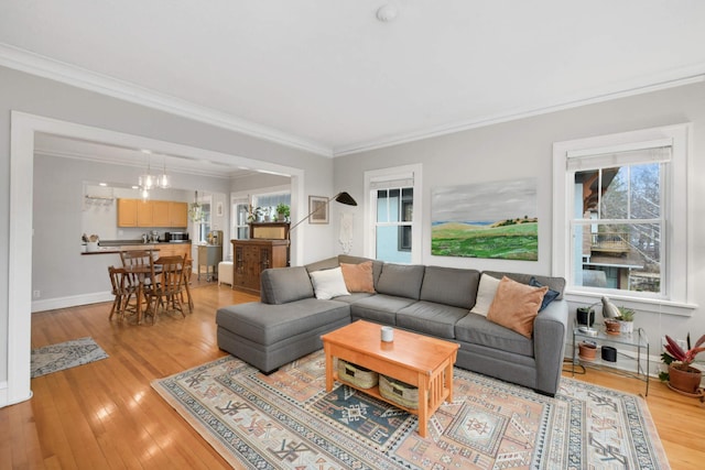 3542 Garfield Ave Unit 3, Minneapolis, MN 55408 - living room with crown molding, light wood-type flooring, and a chandelier
