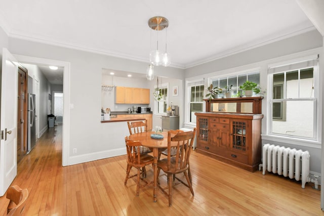 3542 Garfield Ave Unit 3, Minneapolis, MN 55408 - dining area featuring radiator, light wood-type flooring, and ornamental molding