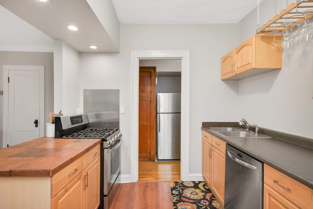3542 Garfield Ave Unit 3, Minneapolis, MN 55408 - kitchen featuring stainless steel appliances, light brown cabinets, light wood-style floors, recessed lighting, and crown molding