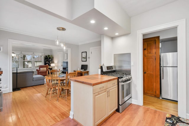 3542 Garfield Ave Unit 3, Minneapolis, MN 55408 - kitchen with stainless steel appliances, wood counters, light wood-style floors, crown molding, and recessed lighting