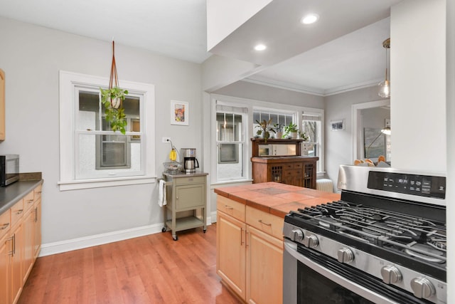 3542 Garfield Ave Unit 3, Minneapolis, MN 55408 - kitchen with appliances with stainless steel finishes, light wood-style flooring, light brown cabinets, tile countertops, and ornamental molding
