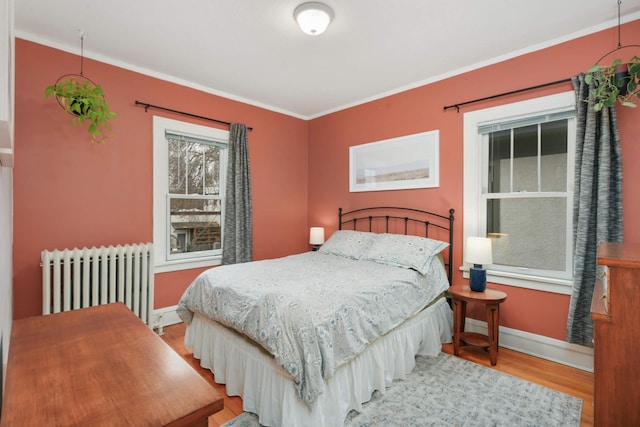 3542 Garfield Ave Unit 3, Minneapolis, MN 55408 - bedroom featuring radiator heating unit, wood finished floors, and ornamental molding