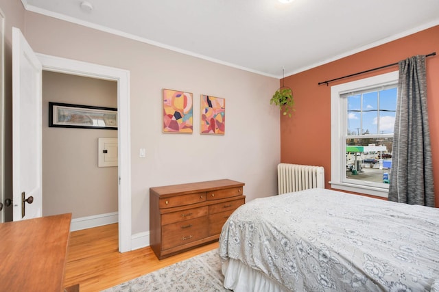 3542 Garfield Ave Unit 3, Minneapolis, MN 55408 - bedroom with radiator, light wood-type flooring, and ornamental molding