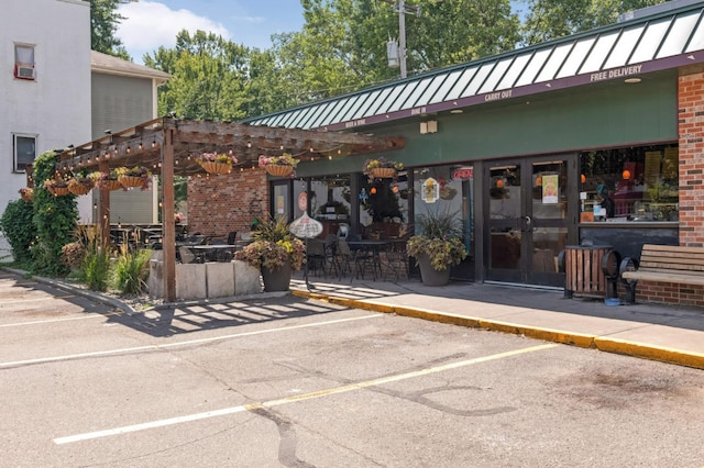 3542 Garfield Ave Unit 3, Minneapolis, MN 55408 - property entrance featuring french doors, brick siding, uncovered parking, a metal roof, and a patio