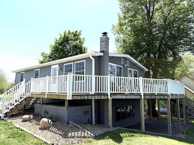 27447 742nd Ave, Dassel Twp, MN 55325 - back of property featuring stairs, a wooden deck, and a chimney