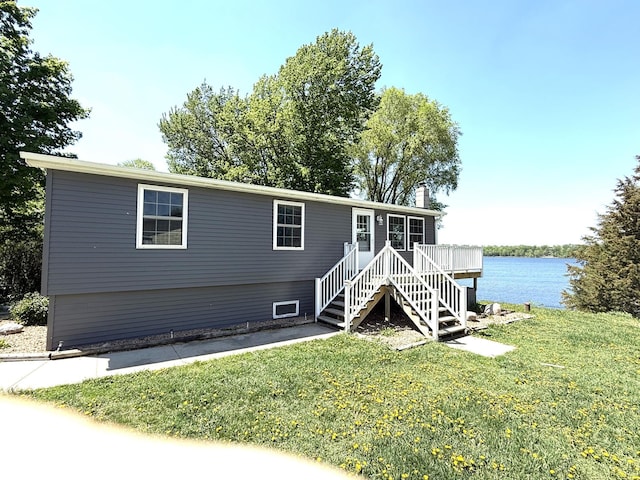 27447 742nd Ave, Dassel Twp, MN 55325 - view of front facade featuring a front lawn, a chimney, stairway, and a deck with water view