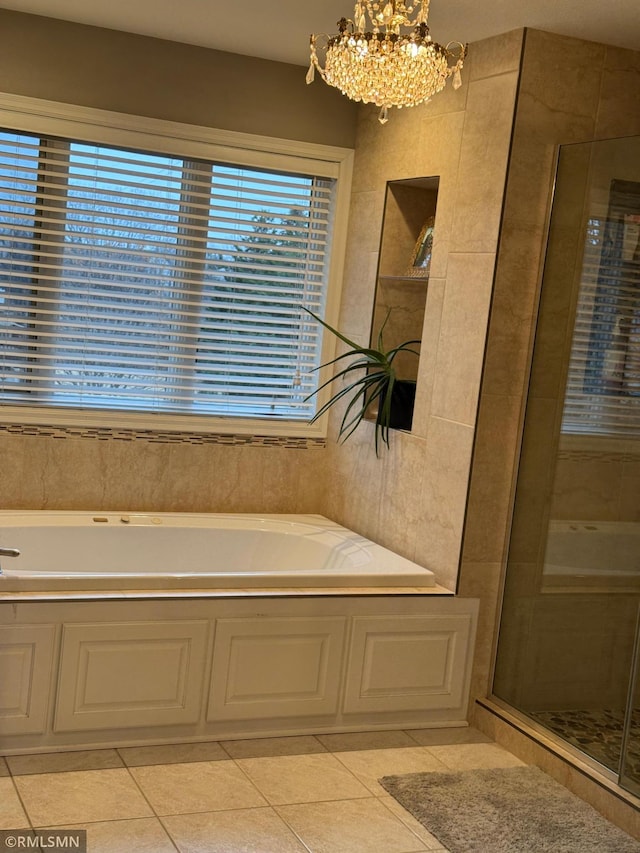 full bathroom with a chandelier, a bath, a shower stall, and tile patterned flooring