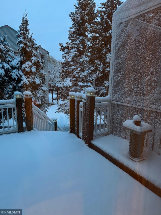 yard layered in snow featuring a balcony