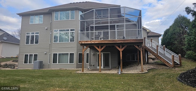 rear view of property featuring a lawn and central AC