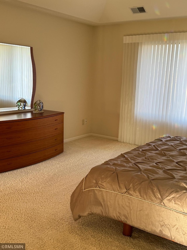 bedroom with visible vents and carpet flooring