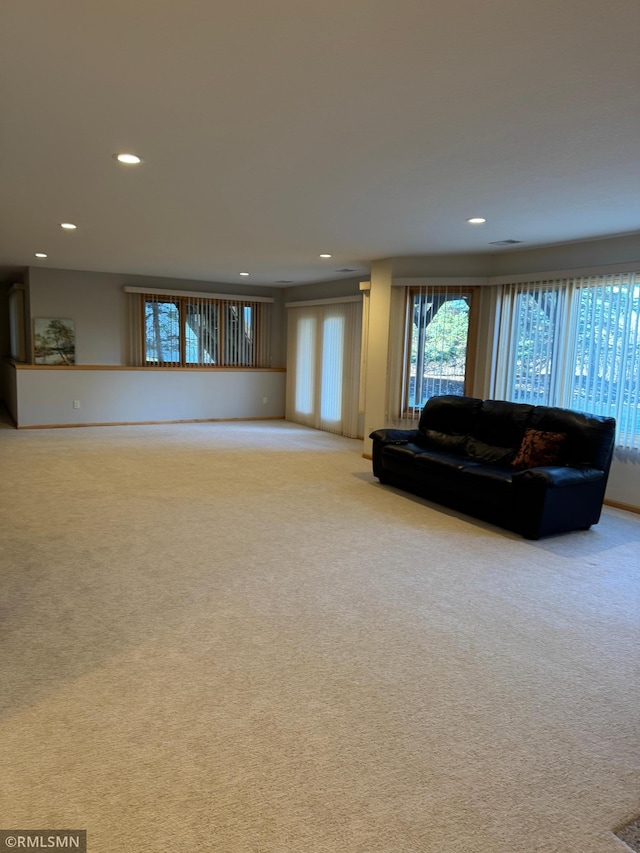 living room with light carpet and recessed lighting