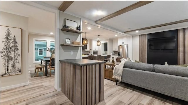 000 Pine Ave S, Sandstone, MN 55072 - kitchen with dark countertops, light wood-type flooring, stainless steel fridge with ice dispenser, white cabinets, and recessed lighting
