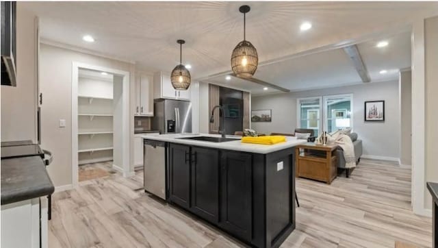 000 Pine Ave S, Sandstone, MN 55072 - kitchen featuring appliances with stainless steel finishes, dark cabinets, light wood-type flooring, white cabinets, and decorative light fixtures