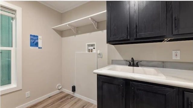 000 Pine Ave S, Sandstone, MN 55072 - laundry room with washer hookup, light wood-style flooring, and cabinet space