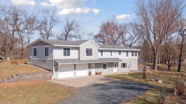 828 143rd St, Garfield Twp, WI 54001 - view of front facade featuring asphalt driveway, a garage, roof with shingles, and a front lawn