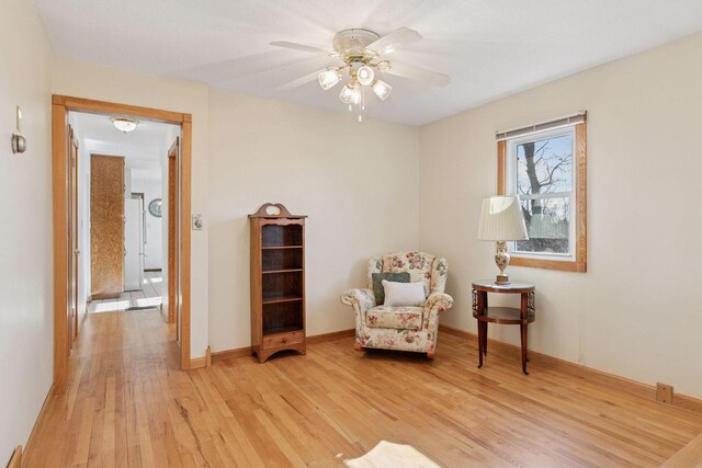 828 143rd St, Garfield Twp, WI 54001 - living area with light wood-style flooring, a ceiling fan, and baseboards