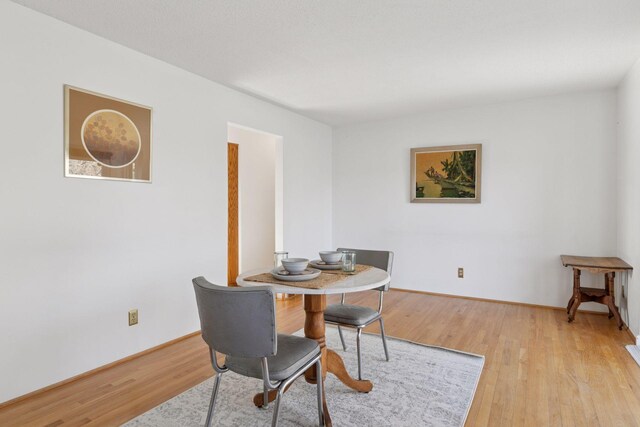 828 143rd St, Garfield Twp, WI 54001 - dining space featuring light wood-style flooring and baseboards