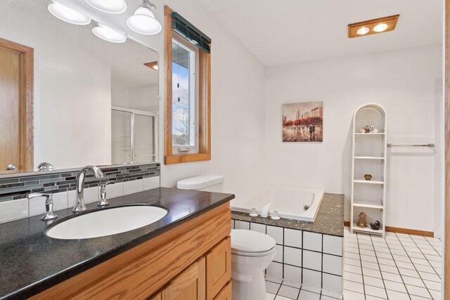 828 143rd St, Garfield Twp, WI 54001 - bathroom with tile patterned flooring, a whirlpool tub, vanity, a stall shower, and toilet