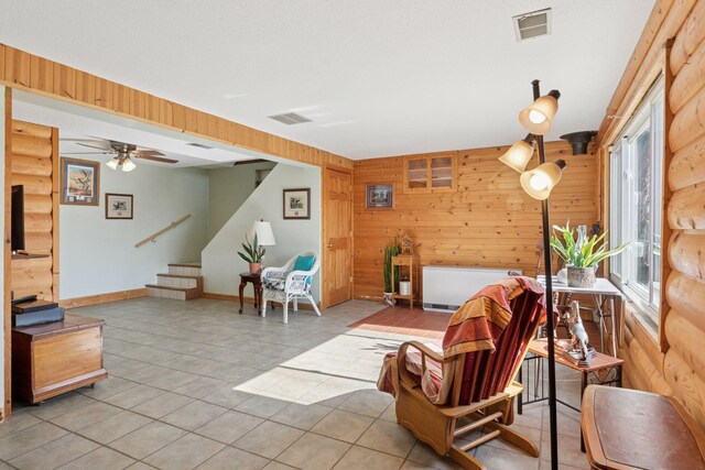 828 143rd St, Garfield Twp, WI 54001 - living room with wood walls, stairs, tile patterned floors, and ceiling fan