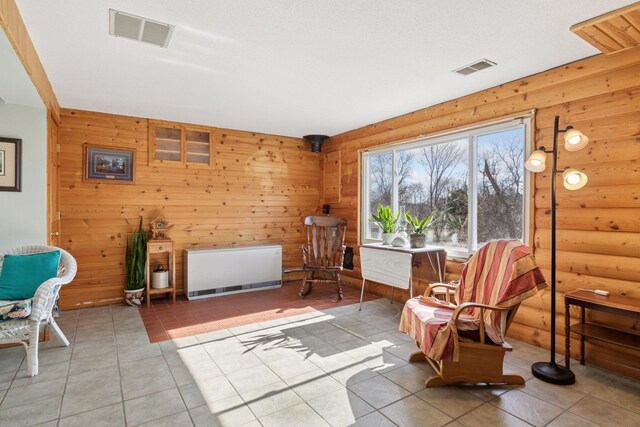 828 143rd St, Garfield Twp, WI 54001 - living area featuring light tile patterned flooring and rustic walls