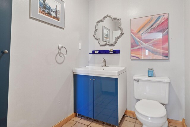828 143rd St, Garfield Twp, WI 54001 - half bathroom featuring baseboards, toilet, vanity, and tile patterned flooring
