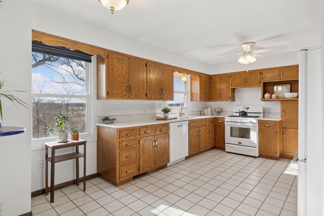 828 143rd St, Garfield Twp, WI 54001 - kitchen featuring white appliances, backsplash, light countertops, and a ceiling fan