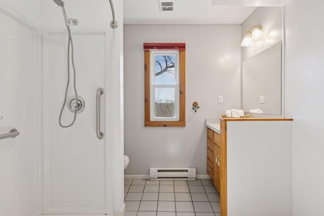 828 143rd St, Garfield Twp, WI 54001 - full bathroom with a baseboard heating unit, a shower stall, vanity, toilet, and tile patterned floors