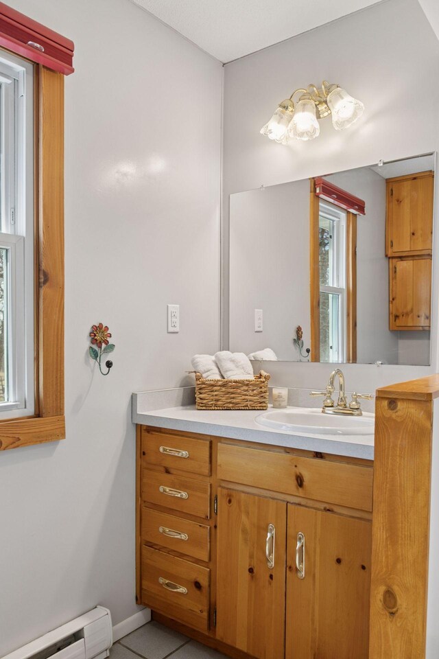 828 143rd St, Garfield Twp, WI 54001 - bathroom featuring a baseboard heating unit, vanity, and baseboards