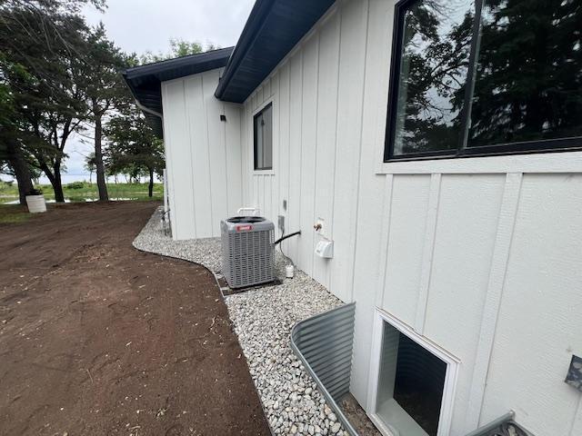 123 River View Rd, Ottertail, MN 56571 - view of home's exterior featuring a central air condition unit and board and batten siding