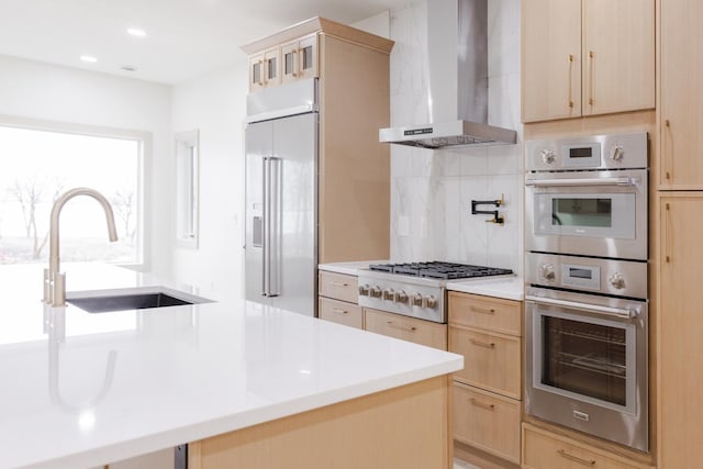 123 River View Rd, Ottertail, MN 56571 - kitchen featuring wall chimney range hood, light brown cabinetry, stainless steel appliances, and light countertops