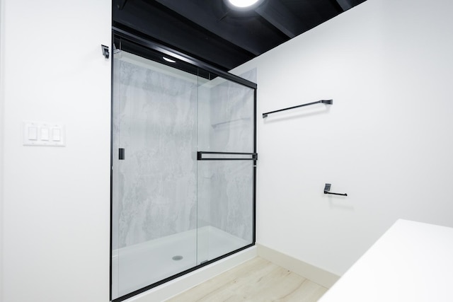 123 River View Rd, Ottertail, MN 56571 - bathroom with a marble finish shower and wood finished floors