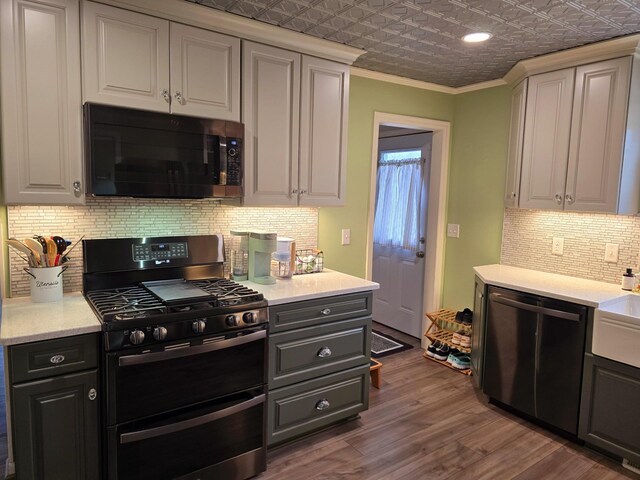 1100 16th Ave NE, Austin, MN 55912 - kitchen featuring an ornate ceiling, double oven range, wood finished floors, dishwasher, and ornamental molding