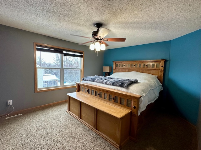 carpeted bedroom with ceiling fan, baseboards, and a textured ceiling