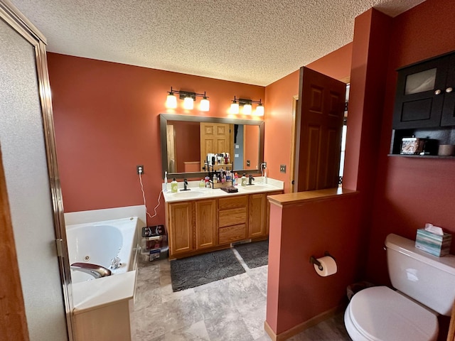 bathroom featuring a textured ceiling, a sink, a whirlpool tub, double vanity, and toilet