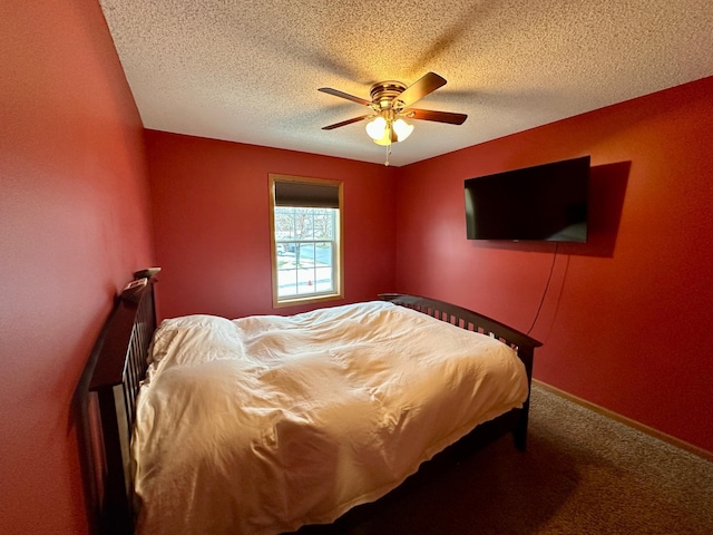 bedroom featuring carpet flooring, a textured ceiling, and ceiling fan