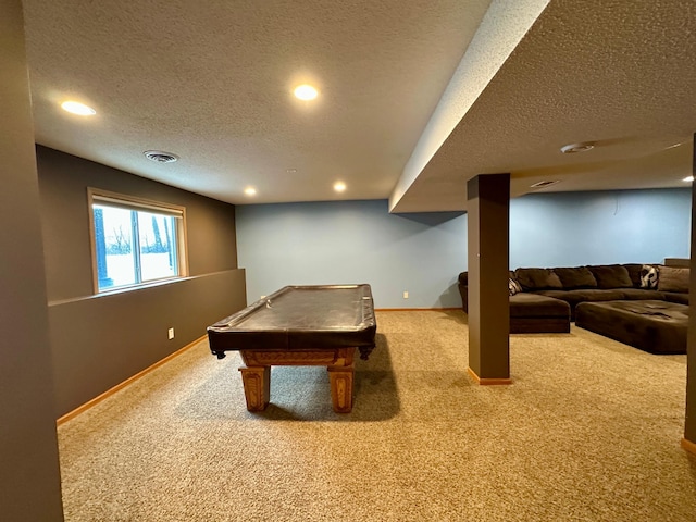 recreation room with a textured ceiling, carpet floors, visible vents, and baseboards