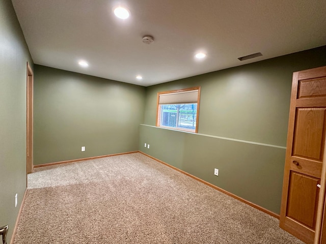 spare room featuring recessed lighting, carpet, visible vents, and baseboards