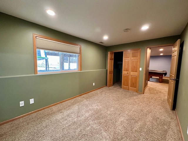 unfurnished bedroom featuring baseboards, visible vents, recessed lighting, and light colored carpet