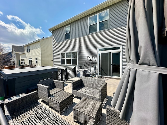 exterior space with an outdoor living space and a hot tub