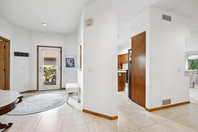 8991 Ferndale Ln, Eden Prairie, MN 55347 - foyer entrance with light tile patterned floors, baseboards, and visible vents
