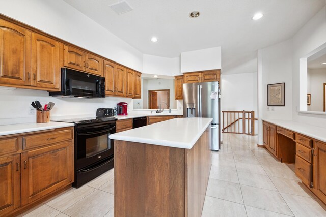 8991 Ferndale Ln, Eden Prairie, MN 55347 - kitchen with a center island, light countertops, light tile patterned flooring, brown cabinets, and black appliances