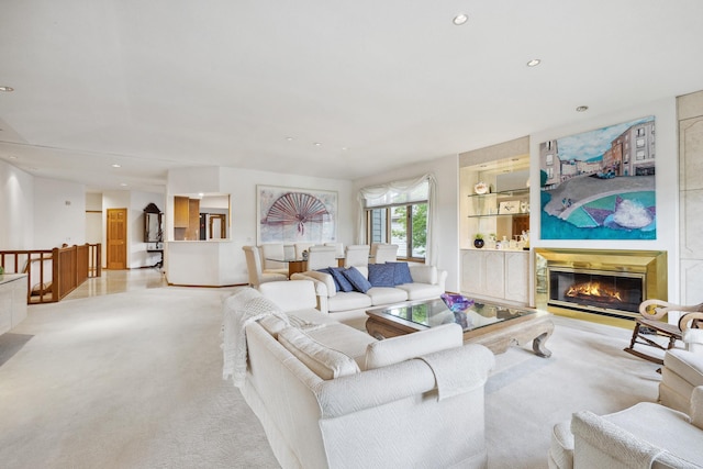 8991 Ferndale Ln, Eden Prairie, MN 55347 - living room with light colored carpet, a glass covered fireplace, built in shelves, and recessed lighting