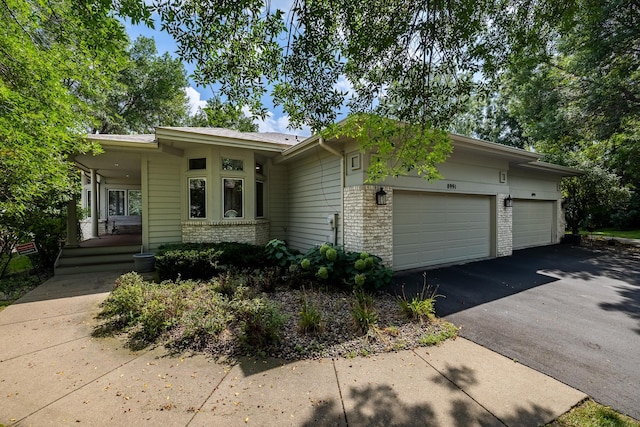 8991 Ferndale Ln, Eden Prairie, MN 55347 - single story home featuring a garage, brick siding, and driveway