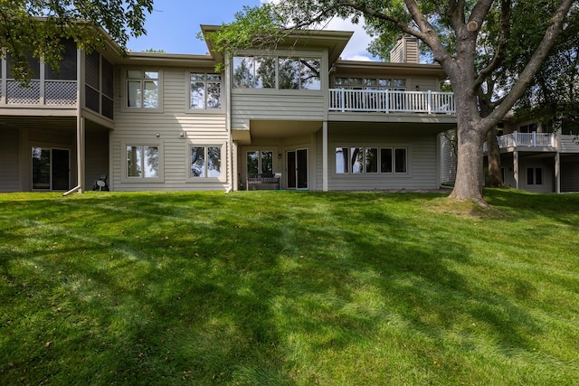 8991 Ferndale Ln, Eden Prairie, MN 55347 - rear view of property featuring a sunroom, a chimney, and a lawn