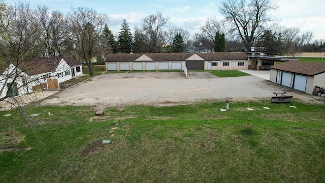 24216 534th Ave, Austin, MN 55912 - exterior space with a lawn, dirt driveway, an outbuilding, and a garage