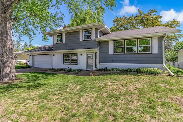 493 Rolls Rd, New Brighton, MN 55112 - tri-level home with a garage, driveway, and a chimney